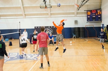 Photo by Jeff Panetti (IST-Junior) Tilted Towers Captain Dylan Forsythe prepares for a spike in Thursday's opening day for IM Volleyball. Forsythe and Tilted Towers won the first match in the tournament over Jacob Sanders' Big ol' Doinks.