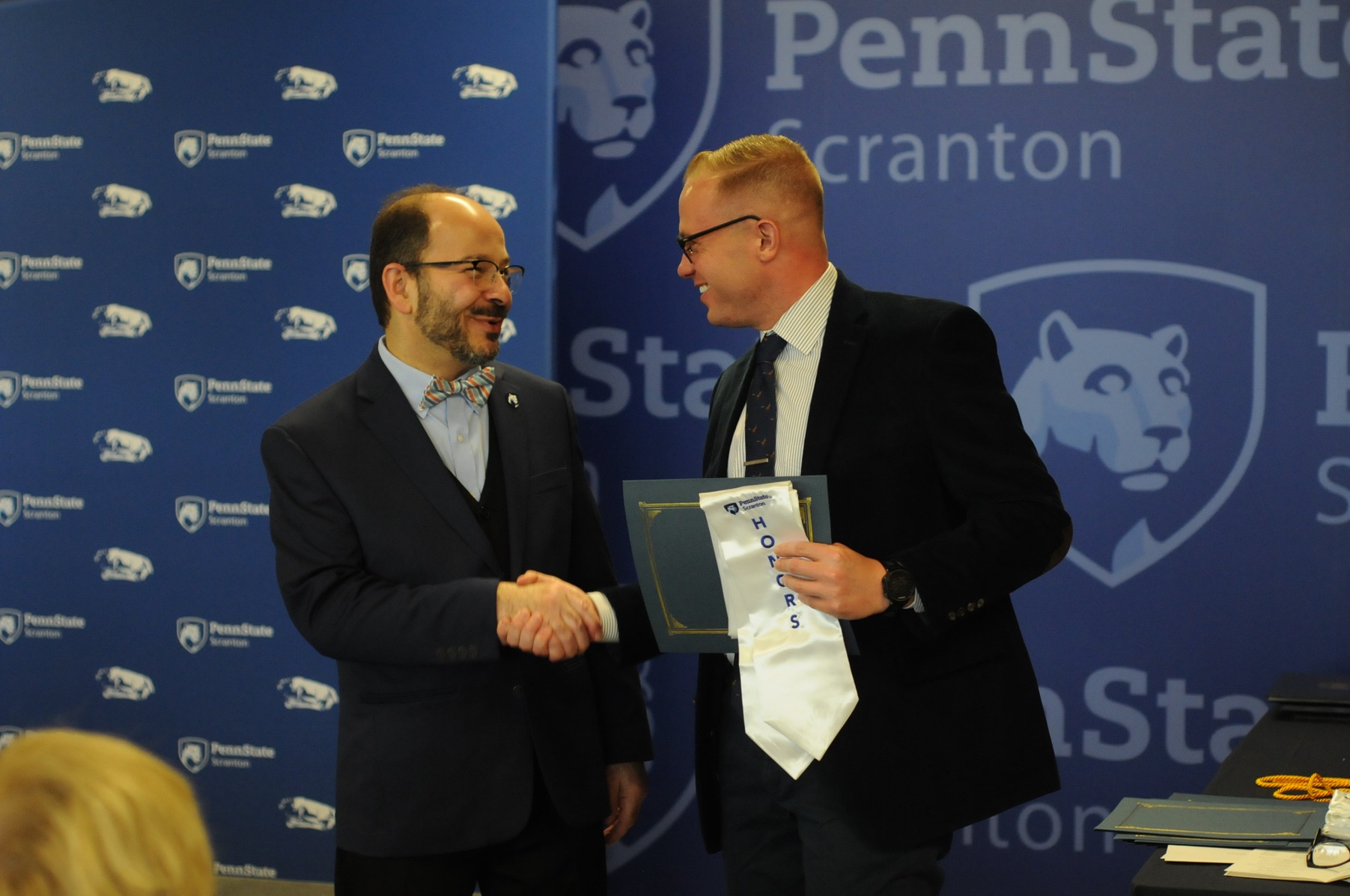 Kyle Franceski (senior- men's cross country) shakes hands with Dr. Wafa, Penn State Scranton's Chancellor, while receiving his second year Honors Certificate.