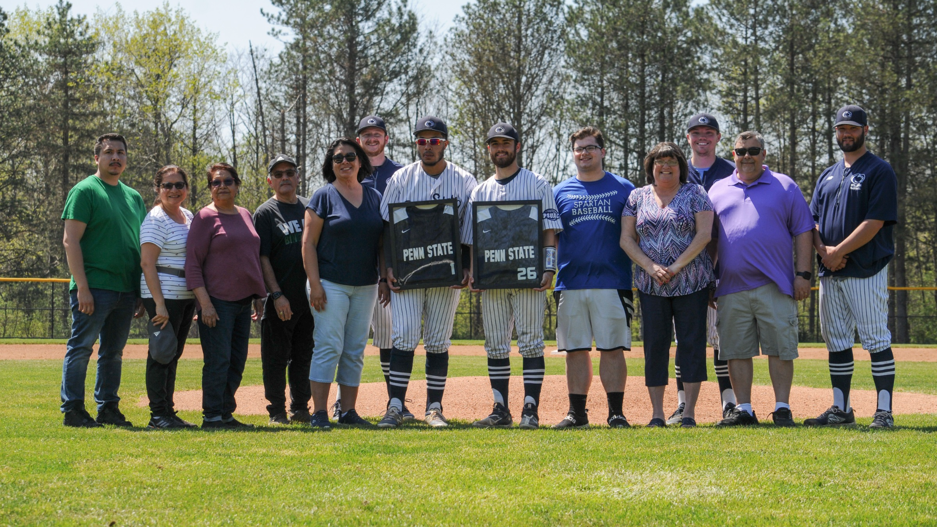 Seniors Mark Longo and Justin Craigg stand at the mound with their families and coaches before Friday's doubleheader.